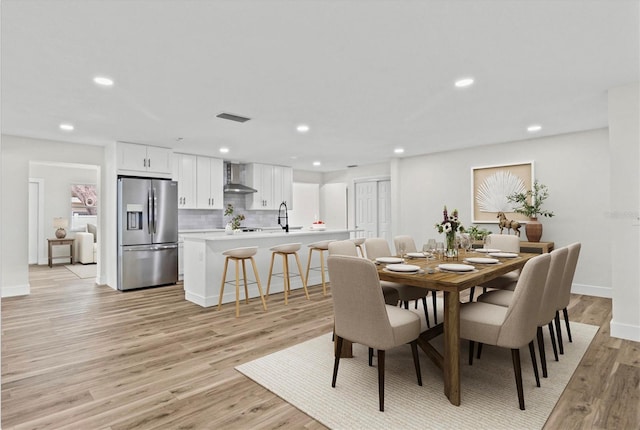 671 25th St SW, Largo, FL 33770 - dining room with light wood-type flooring and recessed lighting