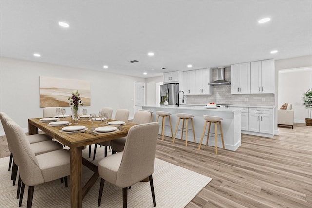 671 25th St SW, Largo, FL 33770 - dining room featuring light wood-style flooring and recessed lighting