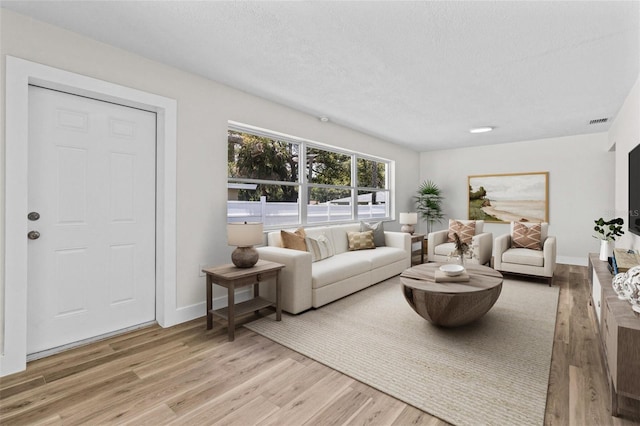 671 25th St SW, Largo, FL 33770 - living room featuring wood finished floors and a textured ceiling