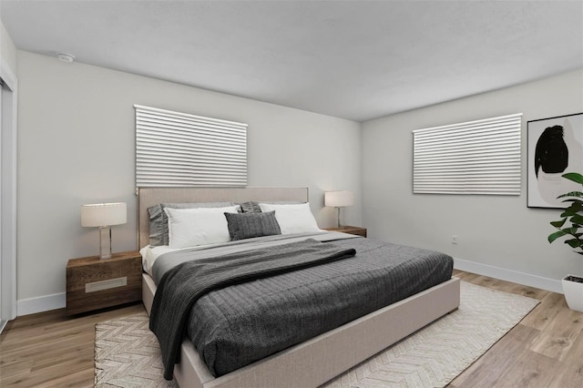 671 25th St SW, Largo, FL 33770 - bedroom with light wood finished floors and baseboards