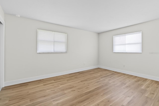 671 25th St SW, Largo, FL 33770 - unfurnished room featuring light wood-style floors and a smoke detector