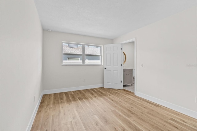 671 25th St SW, Largo, FL 33770 - unfurnished room with light wood-style flooring and baseboards