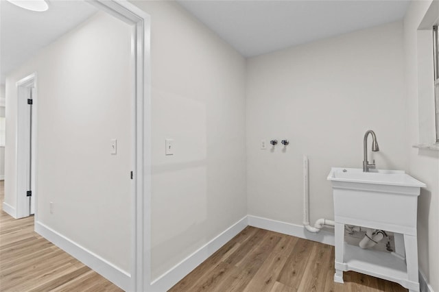 671 25th St SW, Largo, FL 33770 - laundry room with light wood-style flooring and washer hookup