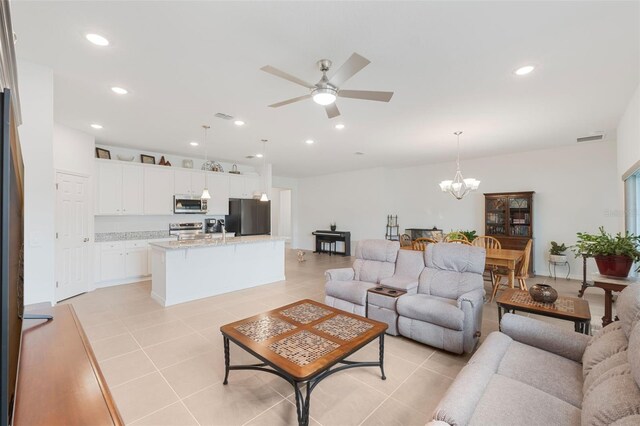 4021 Mayhill Loop, Eustis, FL 32736 - living area with a ceiling fan, a chandelier, light tile patterned floors, and recessed lighting