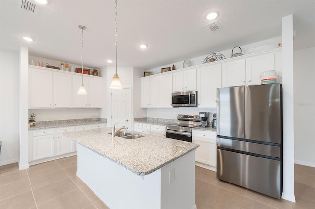 4021 Mayhill Loop, Eustis, FL 32736 - kitchen with appliances with stainless steel finishes, white cabinetry, an island with sink, light tile patterned floors, and recessed lighting