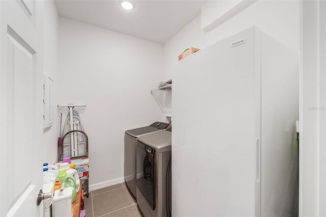 4021 Mayhill Loop, Eustis, FL 32736 - laundry area featuring washing machine and clothes dryer, tile patterned floors, and recessed lighting