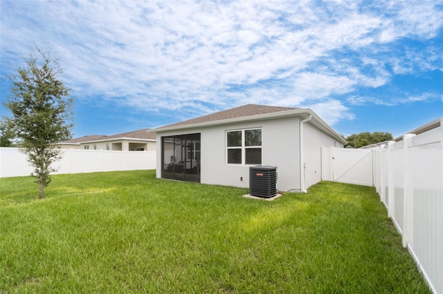 4021 Mayhill Loop, Eustis, FL 32736 - rear view of house with a sunroom, a fenced backyard, stucco siding, and a gate