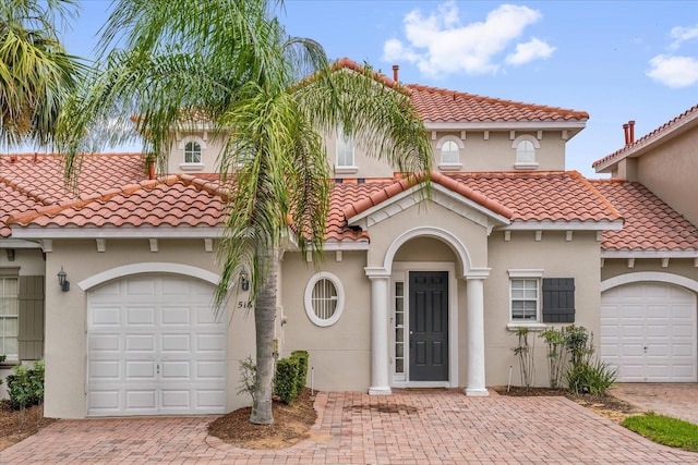 516 Brunello Dr, Davenport, FL 33897 - mediterranean / spanish house featuring a tiled roof, stucco siding, and an attached garage
