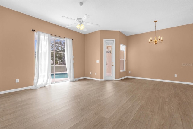 516 Brunello Dr, Davenport, FL 33897 - empty room featuring a chandelier, light wood-type flooring, and a ceiling fan