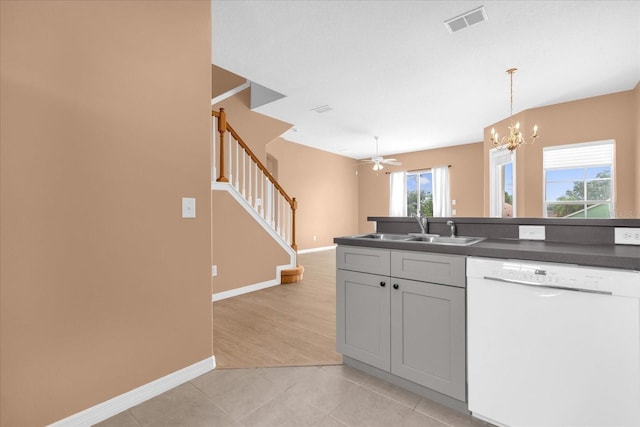 516 Brunello Dr, Davenport, FL 33897 - kitchen with white dishwasher, dark countertops, a chandelier, hanging light fixtures, and ceiling fan