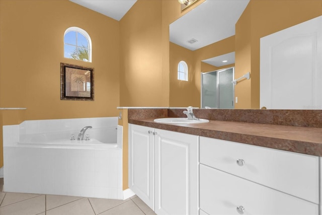 516 Brunello Dr, Davenport, FL 33897 - bathroom featuring tile patterned flooring, a bath, vanity, and a stall shower