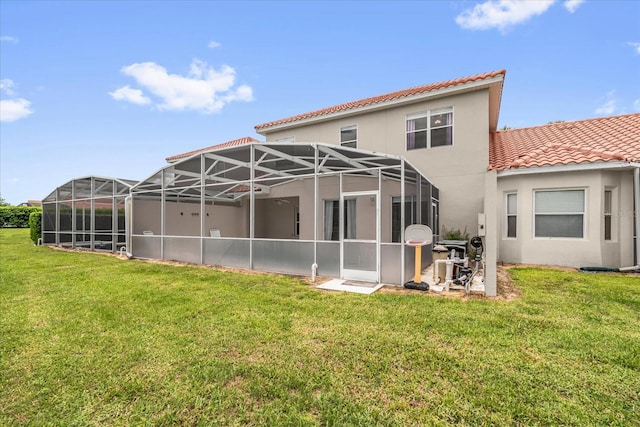 516 Brunello Dr, Davenport, FL 33897 - back of house with a tiled roof, stucco siding, a lawn, and a lanai
