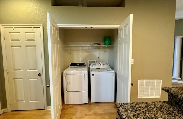 3069 Ashland Ln N, Kissimmee, FL 34741 - washroom featuring washer and dryer and light wood-style floors