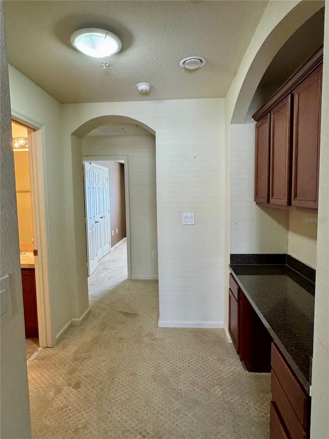 3069 Ashland Ln N, Kissimmee, FL 34741 - hall with arched walkways and light colored carpet