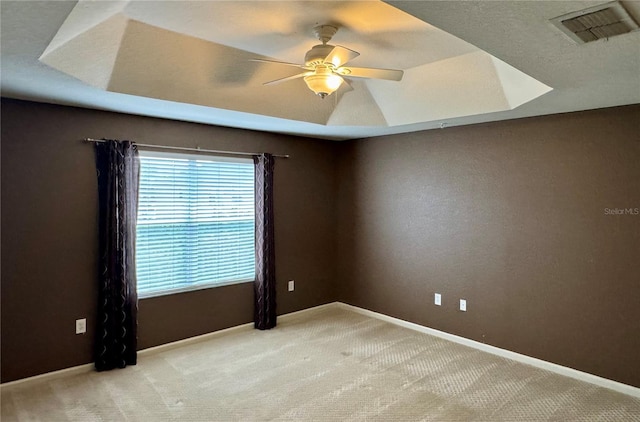 3069 Ashland Ln N, Kissimmee, FL 34741 - empty room featuring ceiling fan, carpet, and a tray ceiling