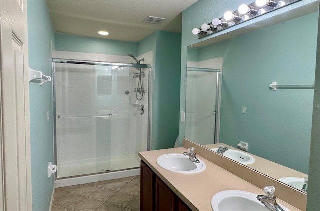 3069 Ashland Ln N, Kissimmee, FL 34741 - full bath featuring a shower stall, double vanity, tile patterned floors, and a textured ceiling