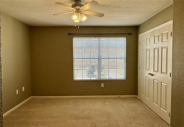 3069 Ashland Ln N, Kissimmee, FL 34741 - unfurnished bedroom with a textured ceiling, light carpet, a closet, and ceiling fan