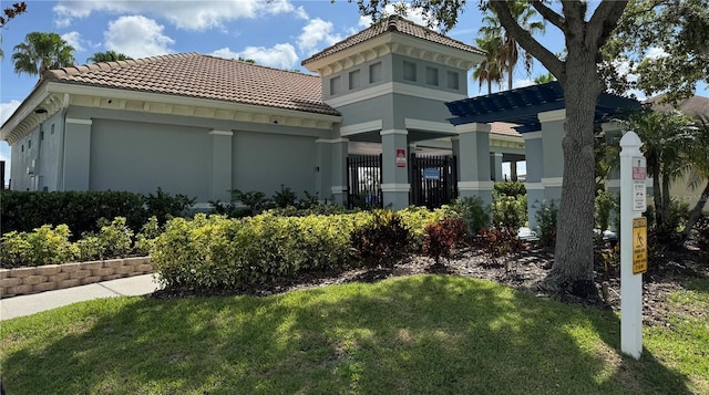 3069 Ashland Ln N, Kissimmee, FL 34741 - view of front of property with a tile roof, stucco siding, and a front lawn