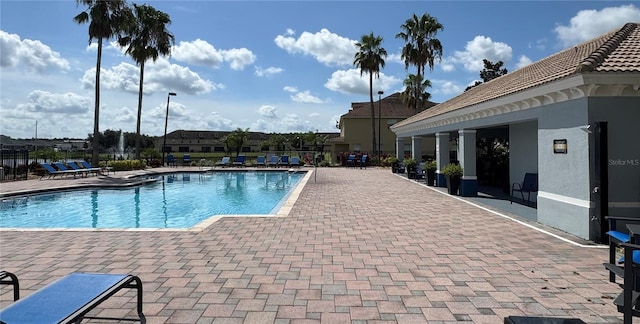 3069 Ashland Ln N, Kissimmee, FL 34741 - community pool featuring a patio area