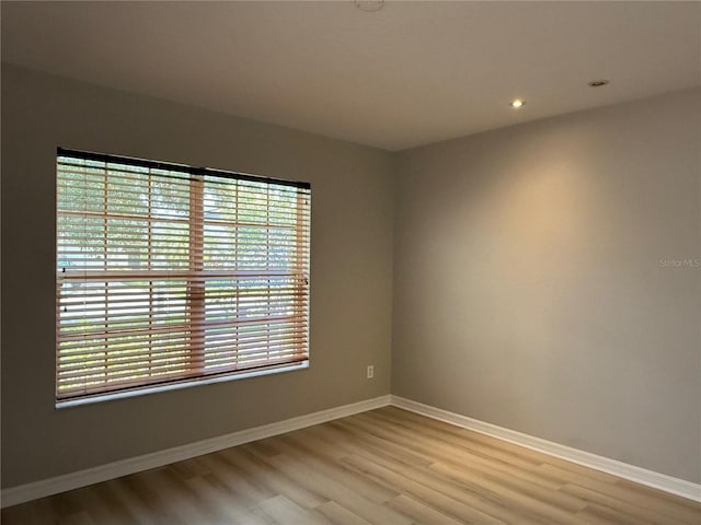 633 Flower Fields Ln, Orlando, FL 32824 - empty room with light wood-type flooring and recessed lighting