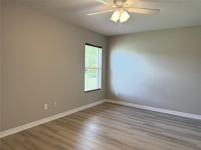 633 Flower Fields Ln, Orlando, FL 32824 - empty room featuring wood finished floors, ceiling fan, and a textured ceiling