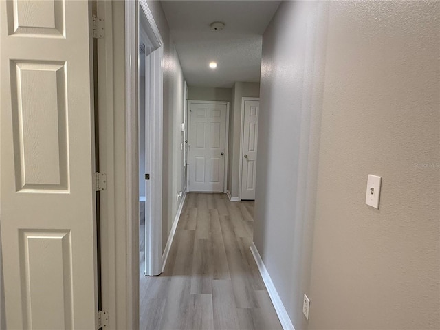 633 Flower Fields Ln, Orlando, FL 32824 - corridor featuring light wood-type flooring and baseboards