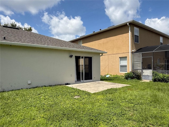 633 Flower Fields Ln, Orlando, FL 32824 - rear view of property featuring stucco siding, a patio, and a lawn