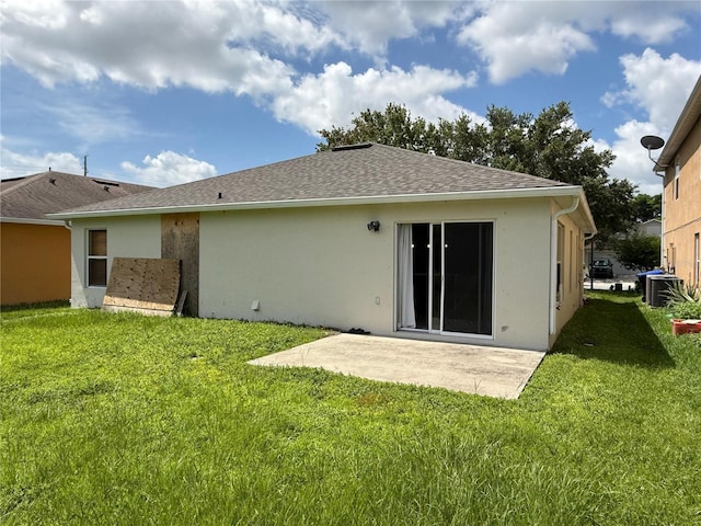 633 Flower Fields Ln, Orlando, FL 32824 - rear view of property with a patio, a lawn, stucco siding, and a shingled roof