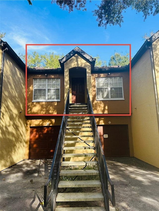 6328 Raleigh St Unit 816, Orlando, FL 32835 - view of front of property with an attached garage, stucco siding, and driveway