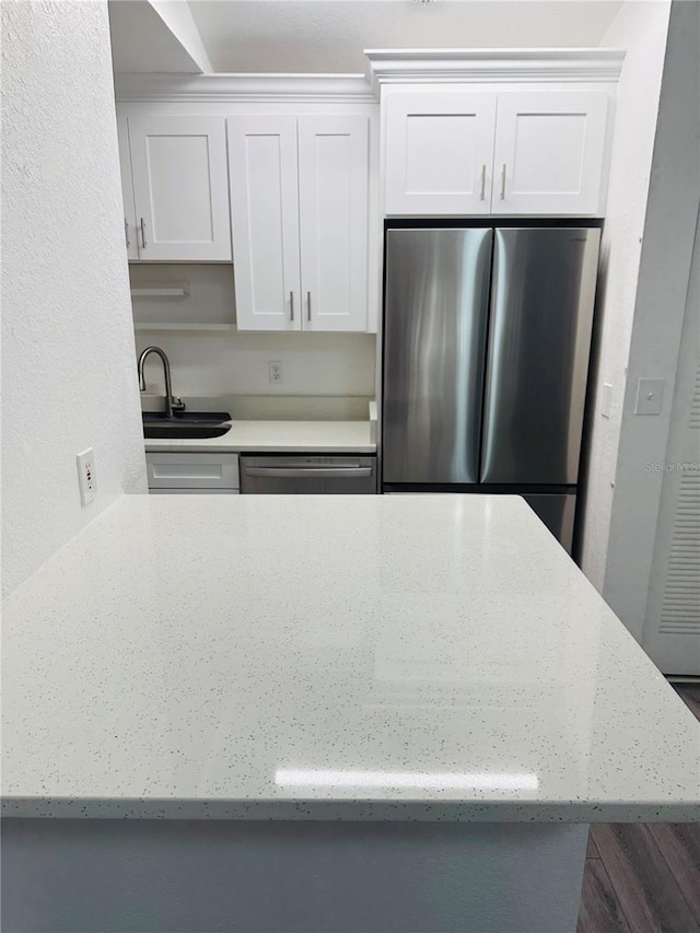 6328 Raleigh St Unit 816, Orlando, FL 32835 - kitchen featuring stainless steel appliances, white cabinets, and light stone countertops
