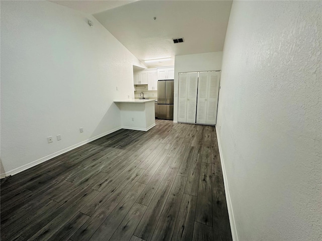 6328 Raleigh St Unit 816, Orlando, FL 32835 - unfurnished living room with dark wood finished floors and a textured wall