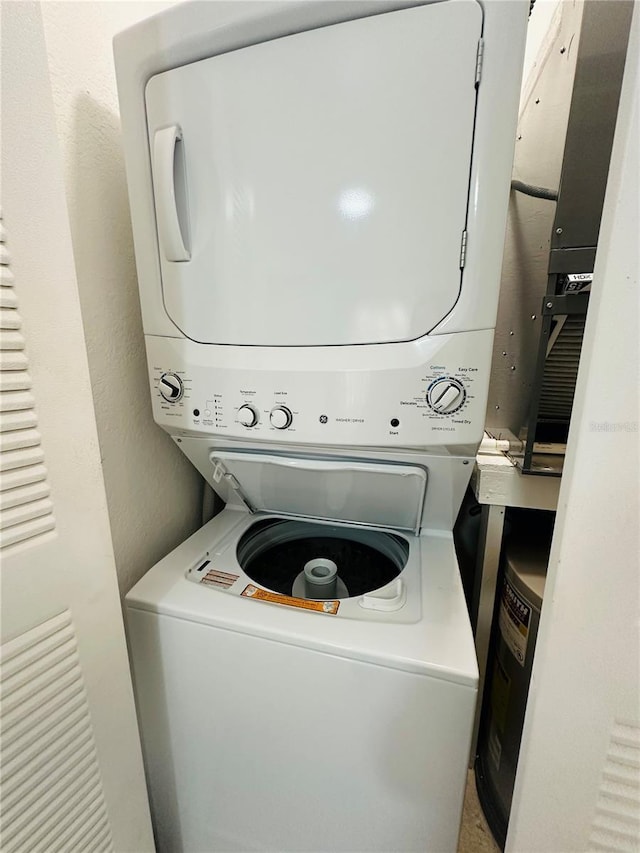 6328 Raleigh St Unit 816, Orlando, FL 32835 - laundry area with stacked washing machine and dryer and a textured wall