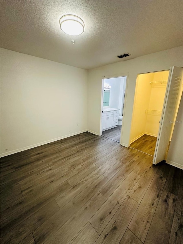 6328 Raleigh St Unit 816, Orlando, FL 32835 - unfurnished bedroom with dark wood-style flooring, a textured ceiling, and ensuite bathroom