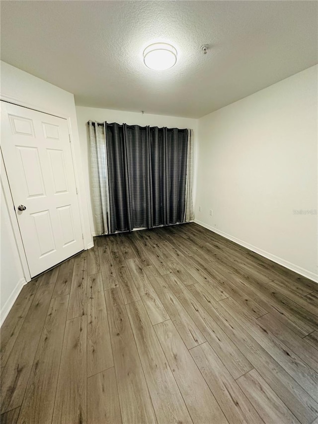 6328 Raleigh St Unit 816, Orlando, FL 32835 - unfurnished room featuring wood finished floors, fire sprinkler in ceiling, and a textured ceiling