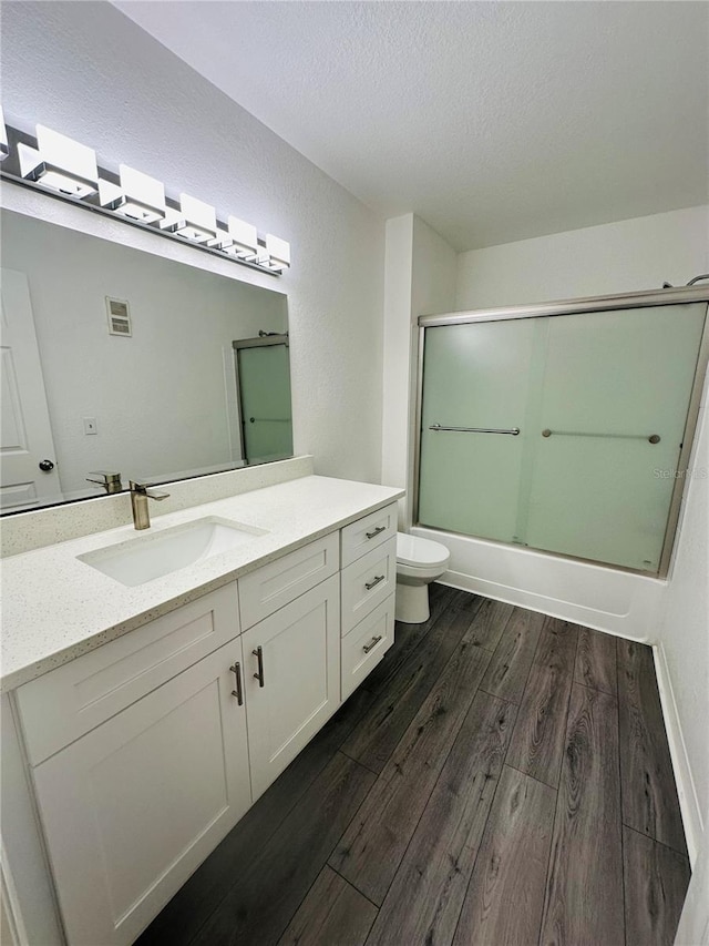 6328 Raleigh St Unit 816, Orlando, FL 32835 - bathroom featuring wood finished floors, vanity, shower / bath combination with glass door, and a textured ceiling