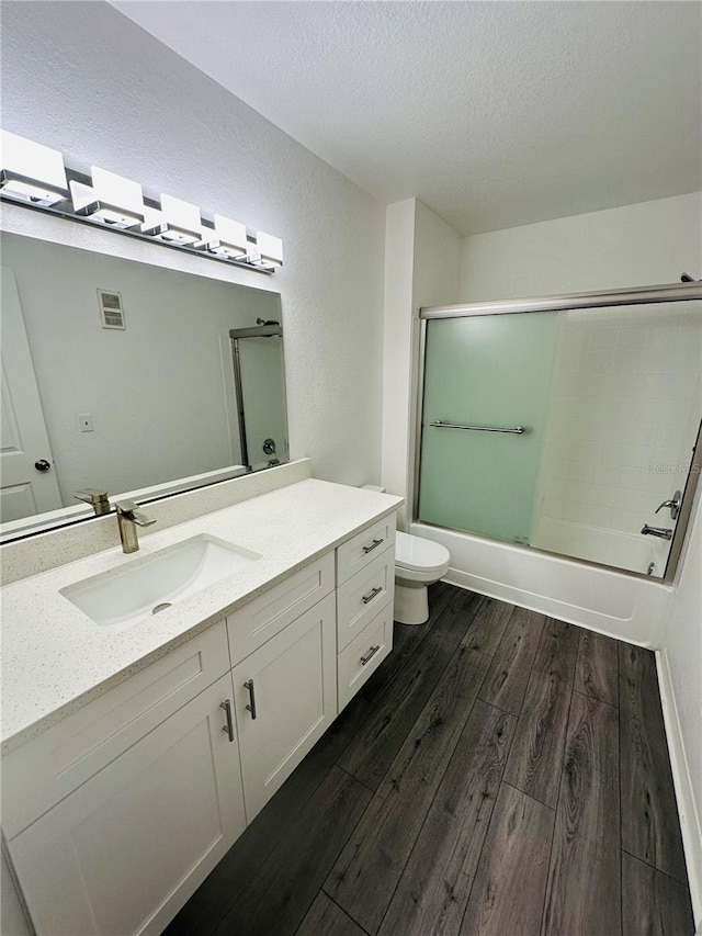 6328 Raleigh St Unit 816, Orlando, FL 32835 - bathroom with wood finished floors, vanity, shower / bath combination with glass door, and a textured ceiling