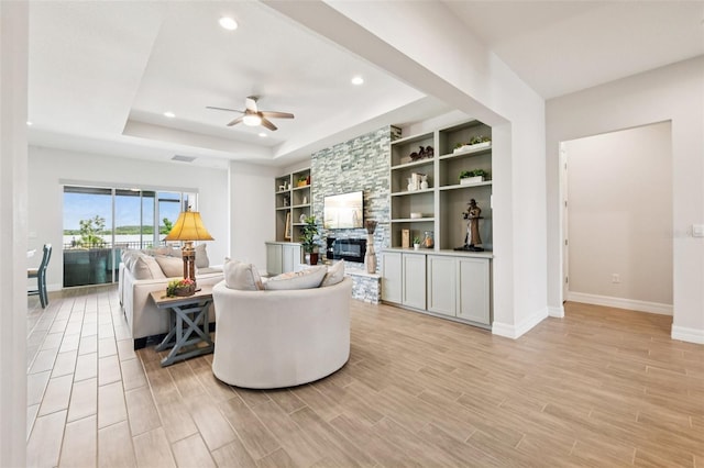 17838 Hither Hills Cir, Winter Garden, FL 34787 - living room with a ceiling fan, light wood-type flooring, a fireplace, recessed lighting, and built in shelves