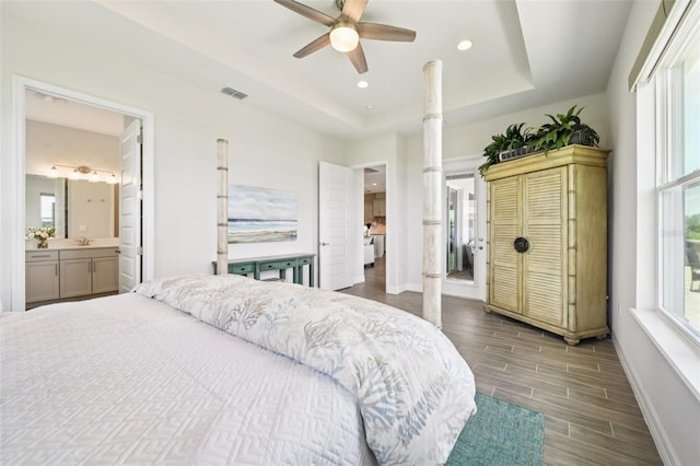 17838 Hither Hills Cir, Winter Garden, FL 34787 - bedroom featuring wood finished floors, a tray ceiling, recessed lighting, a ceiling fan, and ornate columns