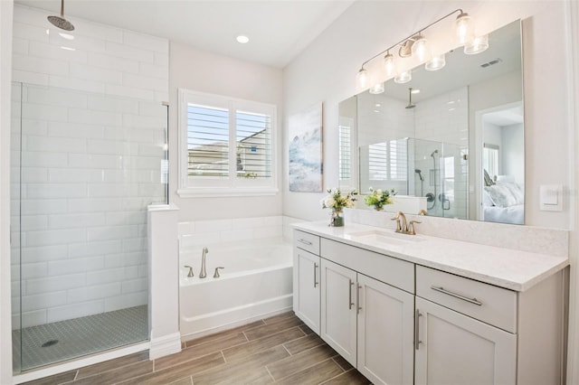 17838 Hither Hills Cir, Winter Garden, FL 34787 - full bath featuring a shower stall, vanity, a garden tub, wood finish floors, and ensuite bath