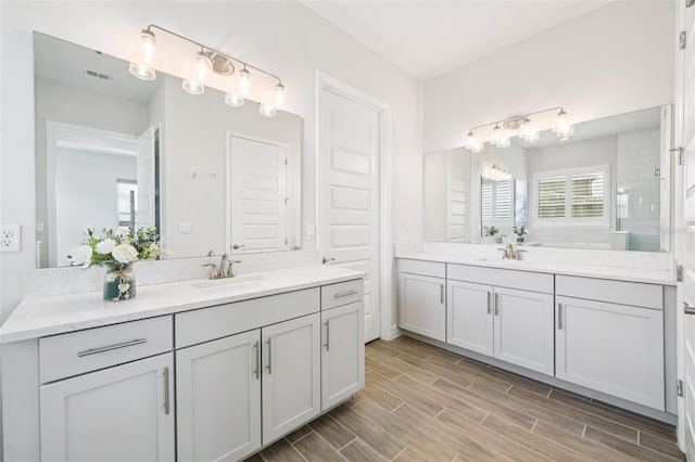 17838 Hither Hills Cir, Winter Garden, FL 34787 - bathroom with two vanities and wood finished floors