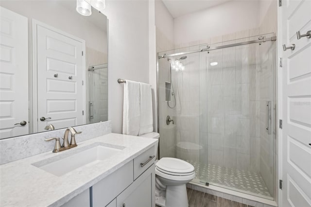 17838 Hither Hills Cir, Winter Garden, FL 34787 - bathroom featuring vanity, a stall shower, and wood finished floors