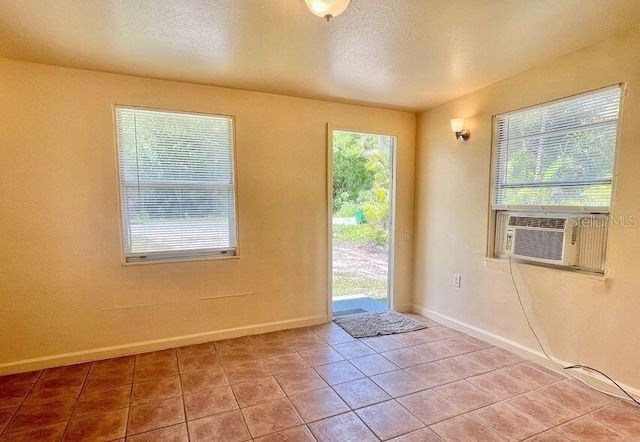 316AND318 Bay Ave, Cocoa, FL 32922 - doorway to outside with light tile patterned floors, a textured ceiling, and cooling unit