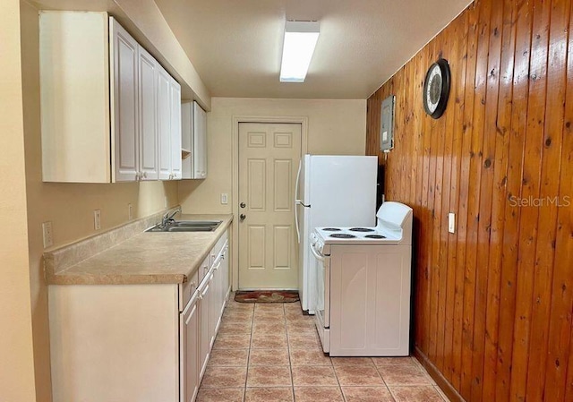 316AND318 Bay Ave, Cocoa, FL 32922 - kitchen featuring white electric range oven, wooden walls, light countertops, light tile patterned floors, and white cabinetry