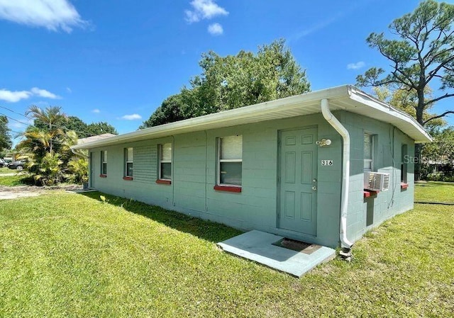 316AND318 Bay Ave, Cocoa, FL 32922 - view of home's exterior featuring a yard, concrete block siding, and cooling unit