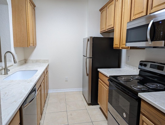 1355 Venezia Ct Unit 201, Davenport, FL 33896 - kitchen with appliances with stainless steel finishes, light stone counters, and light tile patterned floors