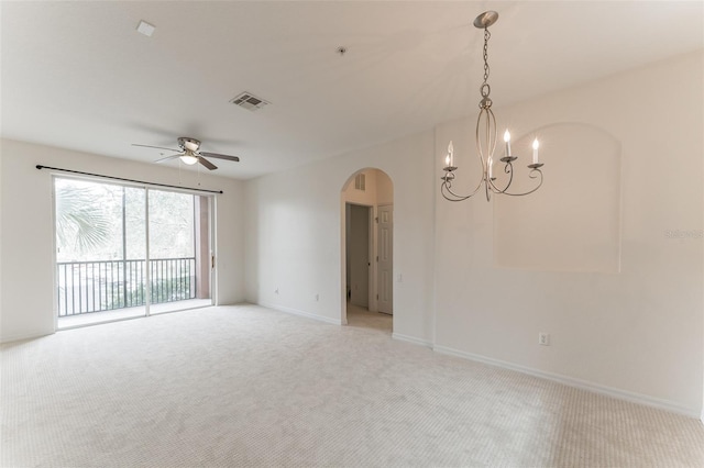 1355 Venezia Ct Unit 201, Davenport, FL 33896 - empty room with arched walkways, light colored carpet, a chandelier, and a ceiling fan