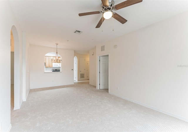 1355 Venezia Ct Unit 201, Davenport, FL 33896 - unfurnished living room with arched walkways and light colored carpet