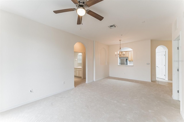 1355 Venezia Ct Unit 201, Davenport, FL 33896 - unfurnished room featuring arched walkways, light colored carpet, a ceiling fan, and a chandelier