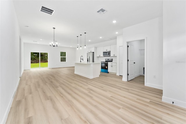9312 N Akola Way, Citrus Springs, FL 34434 - unfurnished living room featuring a chandelier, light wood-style flooring, and recessed lighting