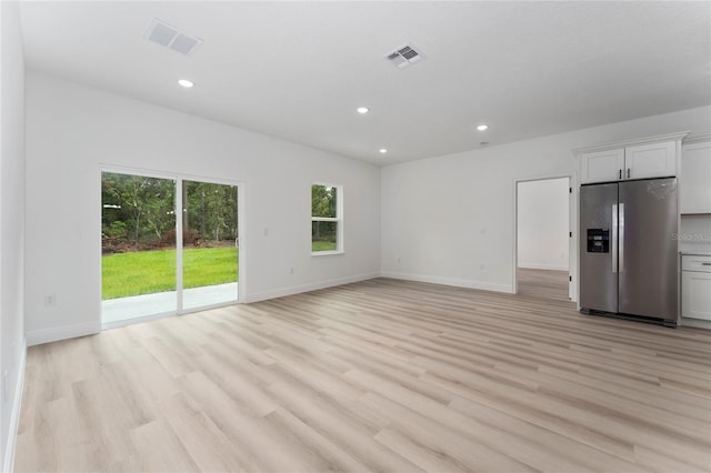 9312 N Akola Way, Citrus Springs, FL 34434 - unfurnished living room featuring recessed lighting and light wood finished floors